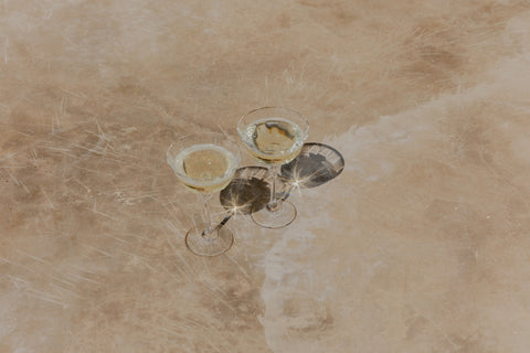 Two glasses of crisp white wine, overhead — wines like Kim Crawford, from Cambridge Wines