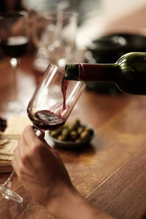 Red wine poured into a glass at Cambridge Wines